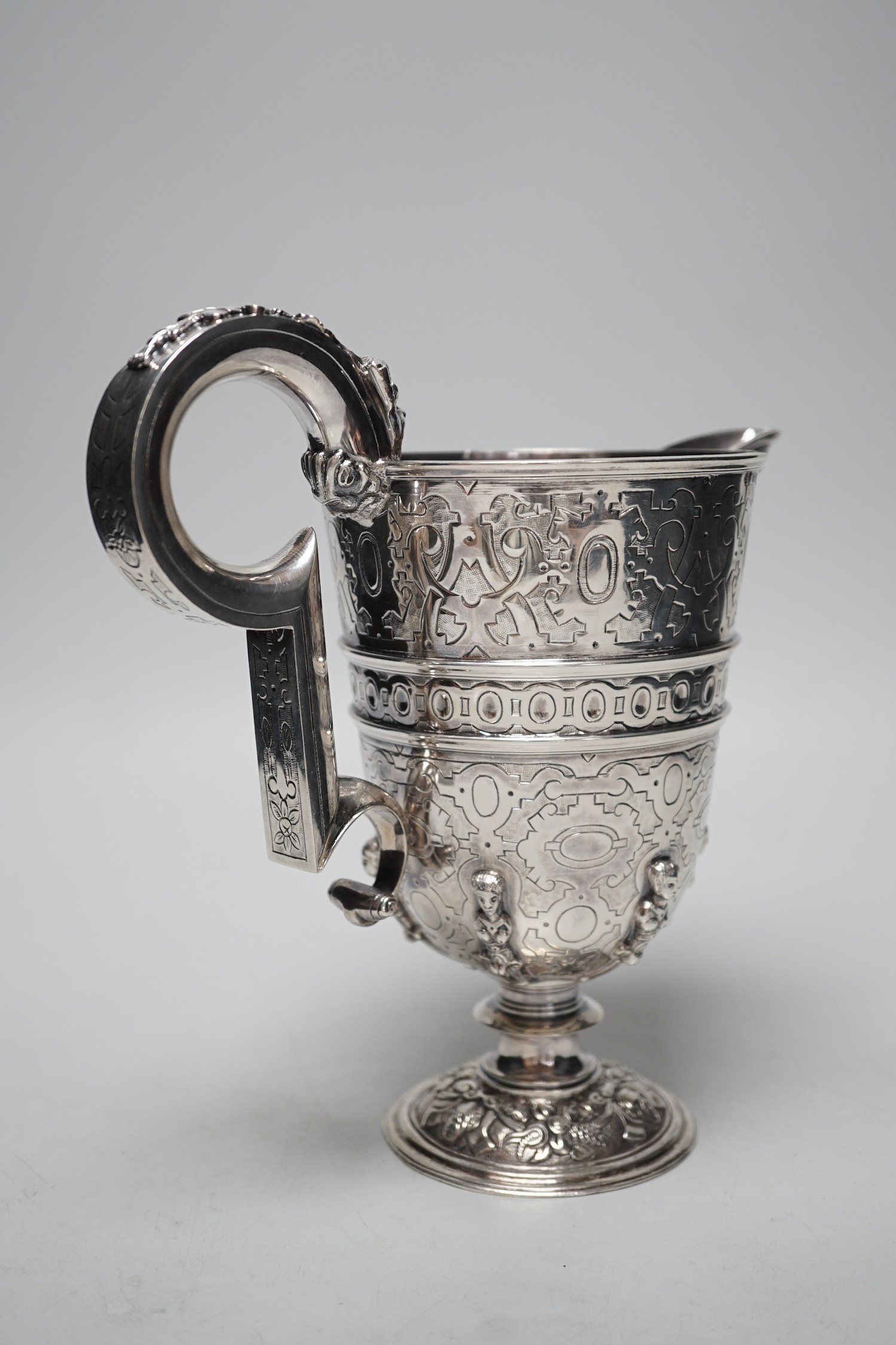 A mid 20th century Spanish? white metal ewer, with engraved, caryatid and mask decoration, height 22.2cm, 26.7oz.